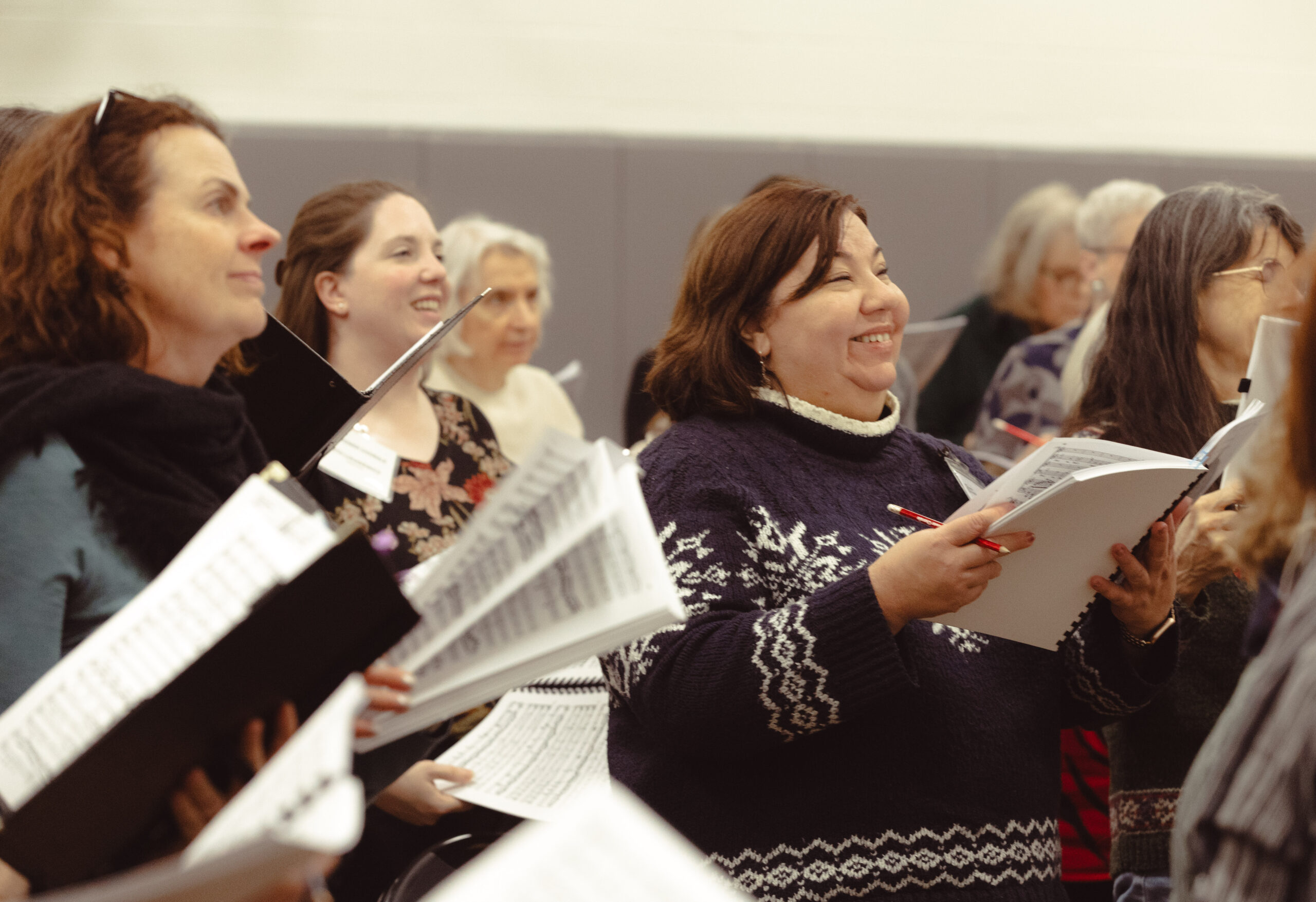 Tower Chorale singers standing with their music, enjoying rehearsing